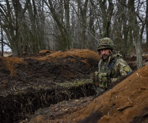 epa10492896 A Ukrainian serviceman of the 68th Separate Jager Infantry Brigade "Oleksa Dovbush" walks in a trench on a frontline position at an undisclosed location in the Donetsk region, eastern Ukraine, 26 February 2023. Russian troops entered Ukraine on 24 February 2022 starting a conflict that has provoked destruction and a humanitarian crisis.  EPA/OLEG PETRASYUK