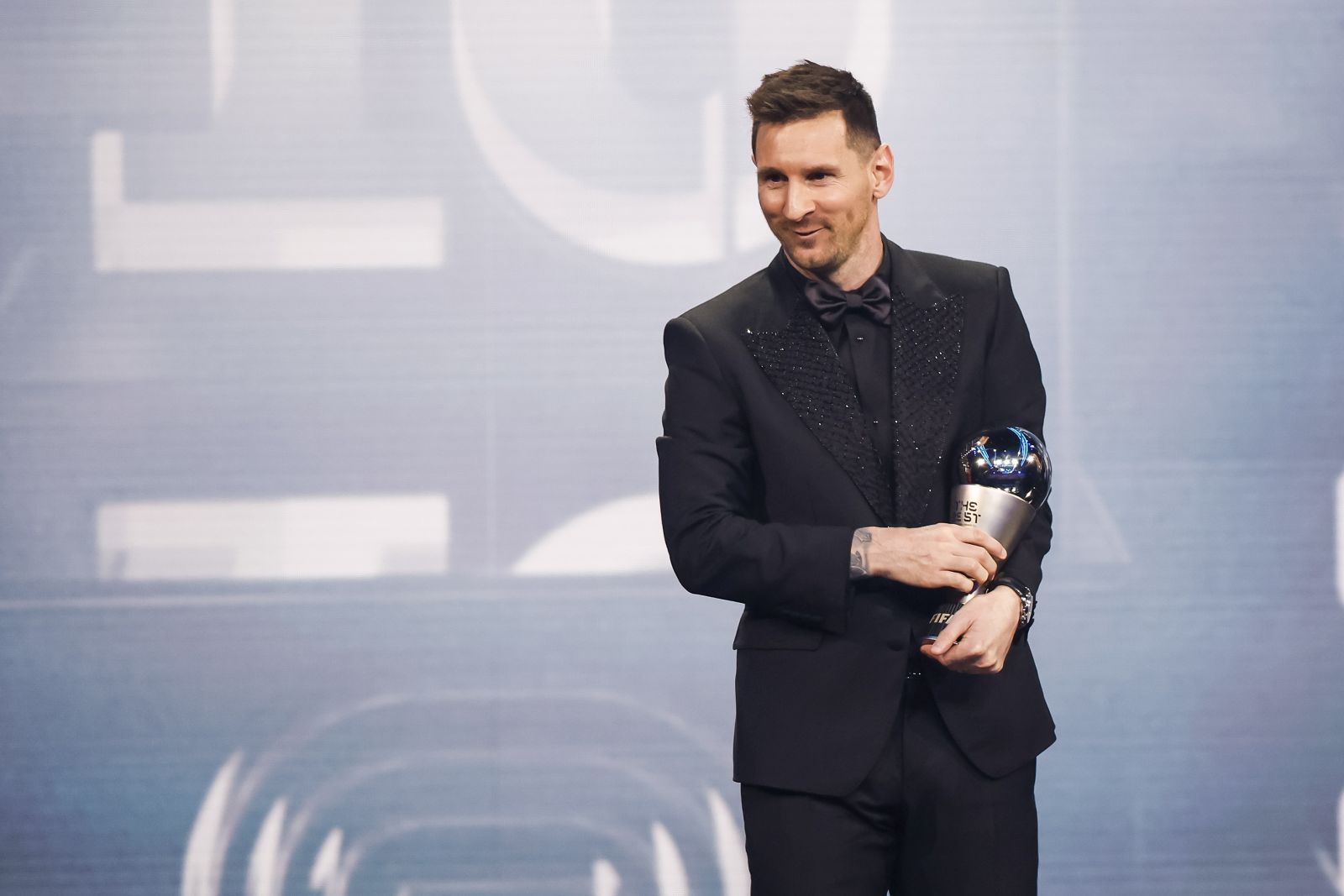 epa10494449 Argentinian soccer player Lionel Messi of Paris Saint-Germain FC with his the Best FIFA Men's Player Award on stage during the The Best FIFA Football Awards 2022 ceremony in Paris, France, 27 February 2023.  EPA/YOAN VALAT