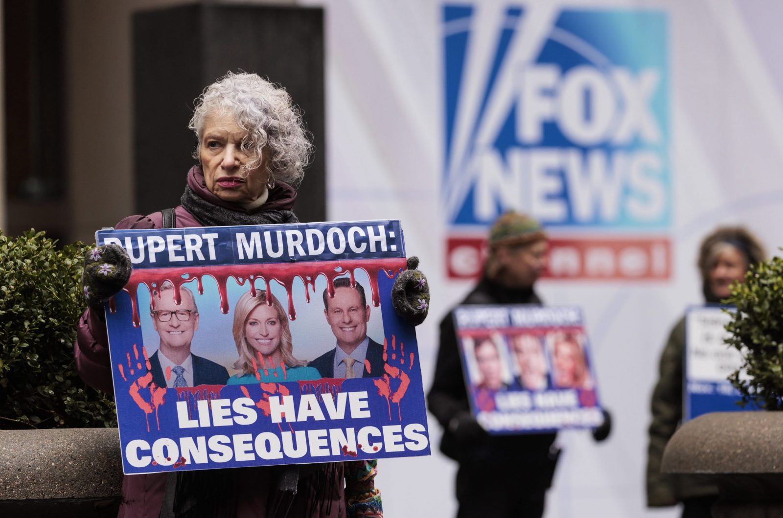epa10495778 Sandy R., of New York, holds a sign while participating in a protest organized by the group Rise and Resist outside of Fox News headquarters in New York, New York, USA, 28 February 2023. A deposition which was recently made public from Dominion Voting Systems’ $1.6 billion defamation lawsuit against Fox shows Rupert Murdoch, the chairman company that owns Fox News, admitting that a number of the television station’s on air personalities promoted the false narrative that the 2020 presidential election was stolen from then President Donald Trump.  EPA/JUSTIN LANE
