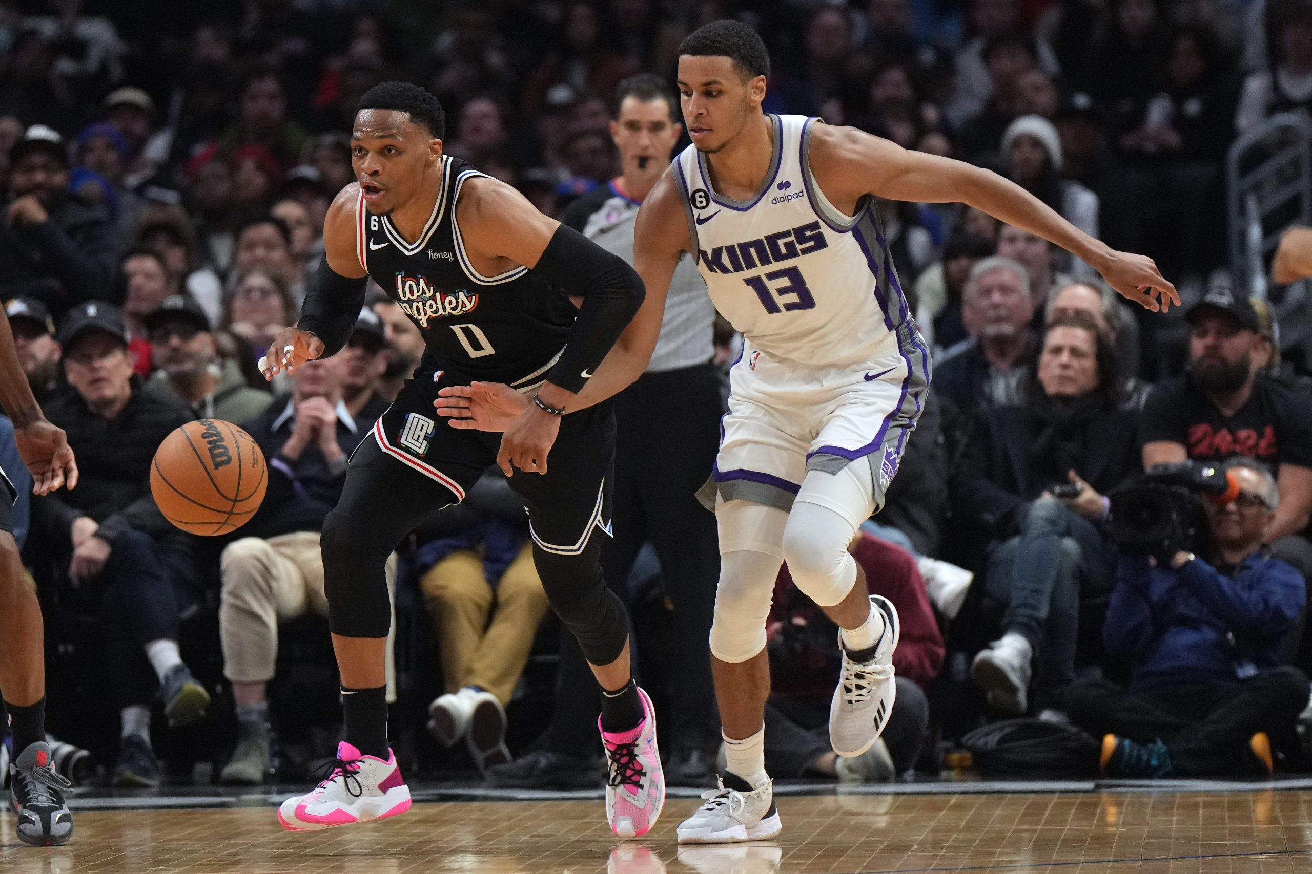 Feb 24, 2023; Los Angeles, California, USA; LA Clippers guard Russell Westbrook (0) and Sacramento Kings forward Keegan Murray (13) battle for the ball in the second half at Crypto.com Arena. The Kings defeated the Clippers 176-175 in double overtime. Mandatory Credit: Kirby Lee-USA TODAY Sports Photo: Kirby Lee/REUTERS
