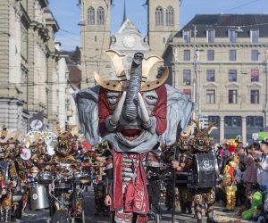 epa10470812 Masked revellers parade through the streets during the carnival season in Lucerne, Switzerland, 16 February 2023.  EPA/URS FLUEELER