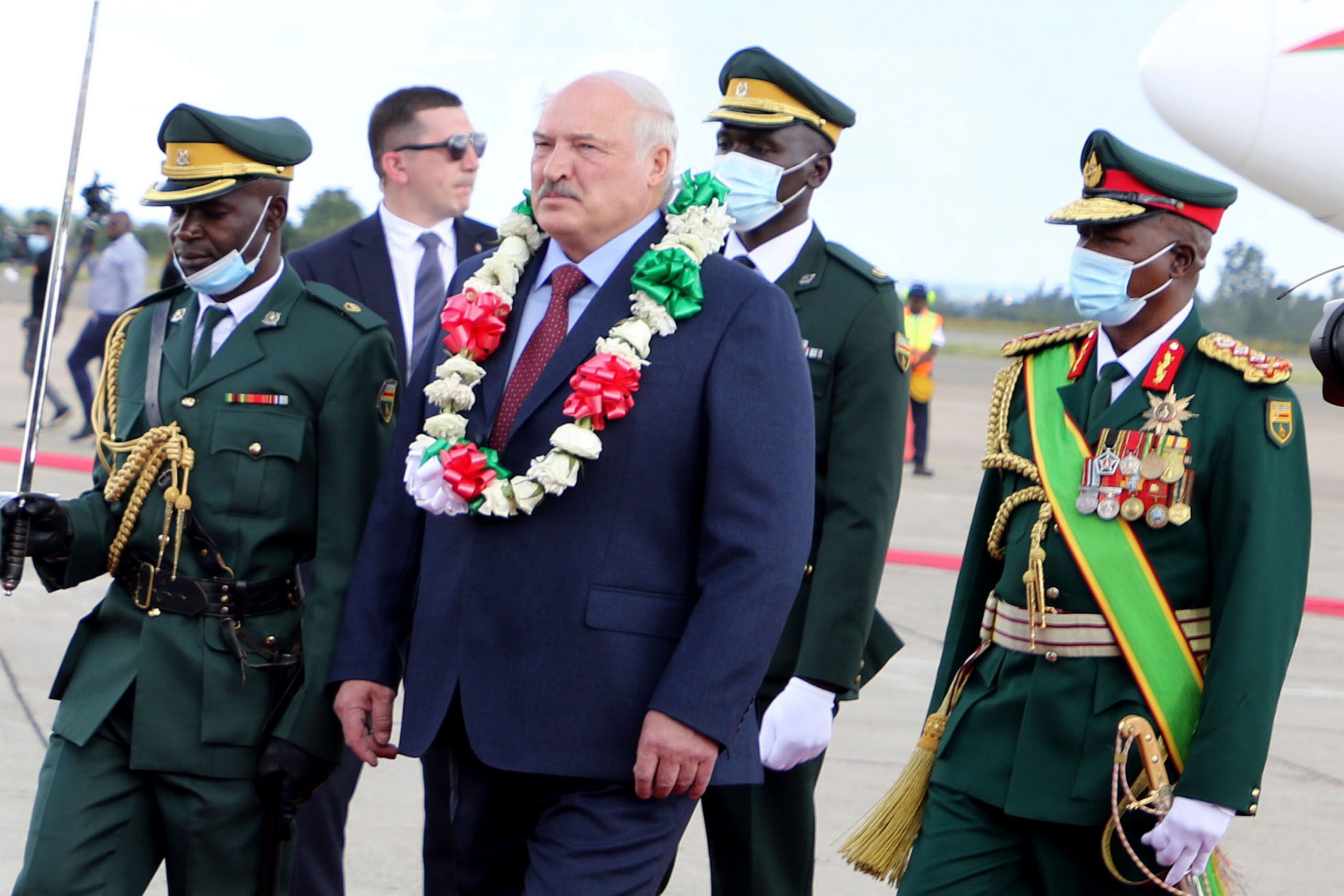 epa10440306 Belarusian President Alexander Lukashenko (C) inspects guards of honor upon arrival at the Robert Mugabe International airport in Harare, Zimbabwe, 30 January 2023. Lukashenko arrived on a two-day state visit to Zimbabwe, the first by Lukashenko to a Sub-Saharan African nation, during which he will have talks on strengthening bilateral ties.  EPA/AARON UFUMELI