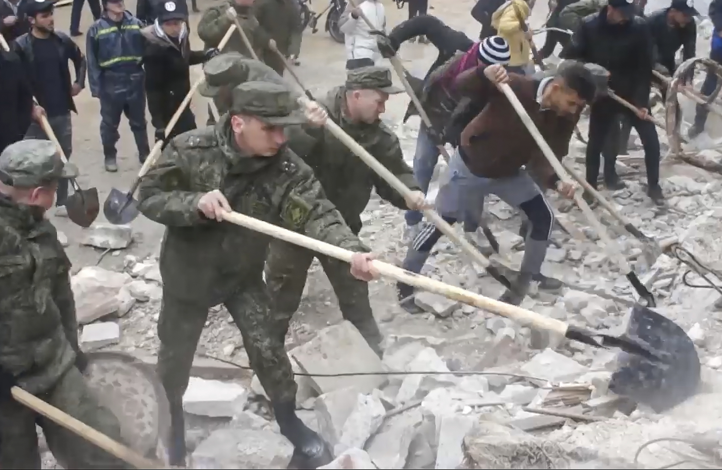 epa10452107 A still image taken from a handout video provided by the Russian Defence Ministry Press-Service on 07 February 2023 shows Russian servicemen searching for victims at the site of a collapsed building after a major earthquake in Latakia, Syria. More than 4,000 people were killed and thousands more injured after a major 7.8 magnitude earthquake struck southern Turkey and northern Syria on 06 February. Authorities fear the death toll will keep climbing as rescuers look for survivors across the region.  EPA/RUSSIAN DEFENCE MINISTRY PRESS SERVICE HANDOUT -- BEST QUALITY AVAILABLE -- MANDATORY CREDIT -- HANDOUT EDITORIAL USE ONLY/NO SALES