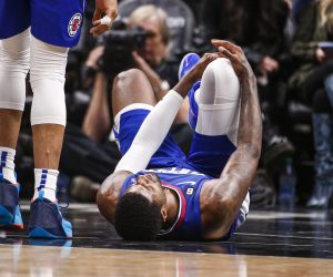 Los Angeles Clippers forward Paul George, right, lies on the court after an injury during the second half of an the team's NBA basketball game against the Oklahoma City Thunder on Tuesday, March 21, 2023, in Los Angeles. (AP Photo/Ringo H.W. Chiu)