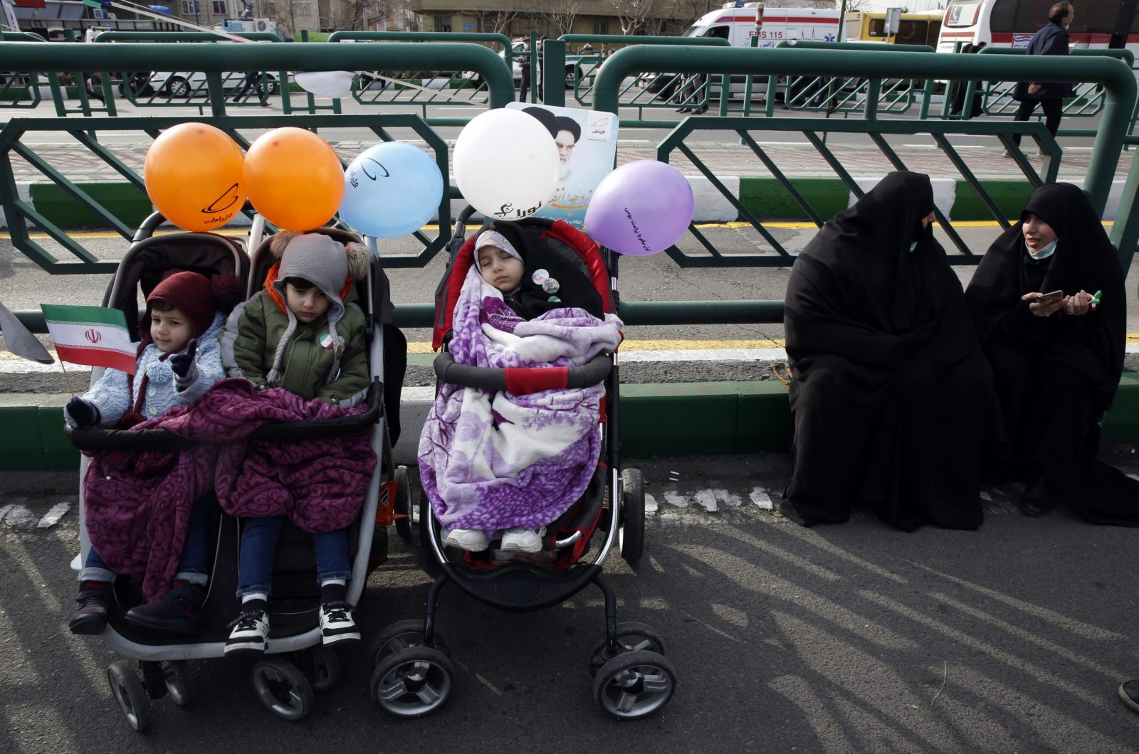 epa10460371 Iranian women sit next to their child during the 44th anniversary of the 1979 Islamic Revolution, at the Azadi (Freedom) square in Tehran, Iran, 11 February 2023. The event marks the 44th anniversary of the Islamic revolution, which came ten days after Ayatollah Ruhollah Khomeini's returned from his exile in Paris to Iran, toppling the monarchy system and forming the Islamic Republic  EPA/ABEDIN TAHERKENAREH