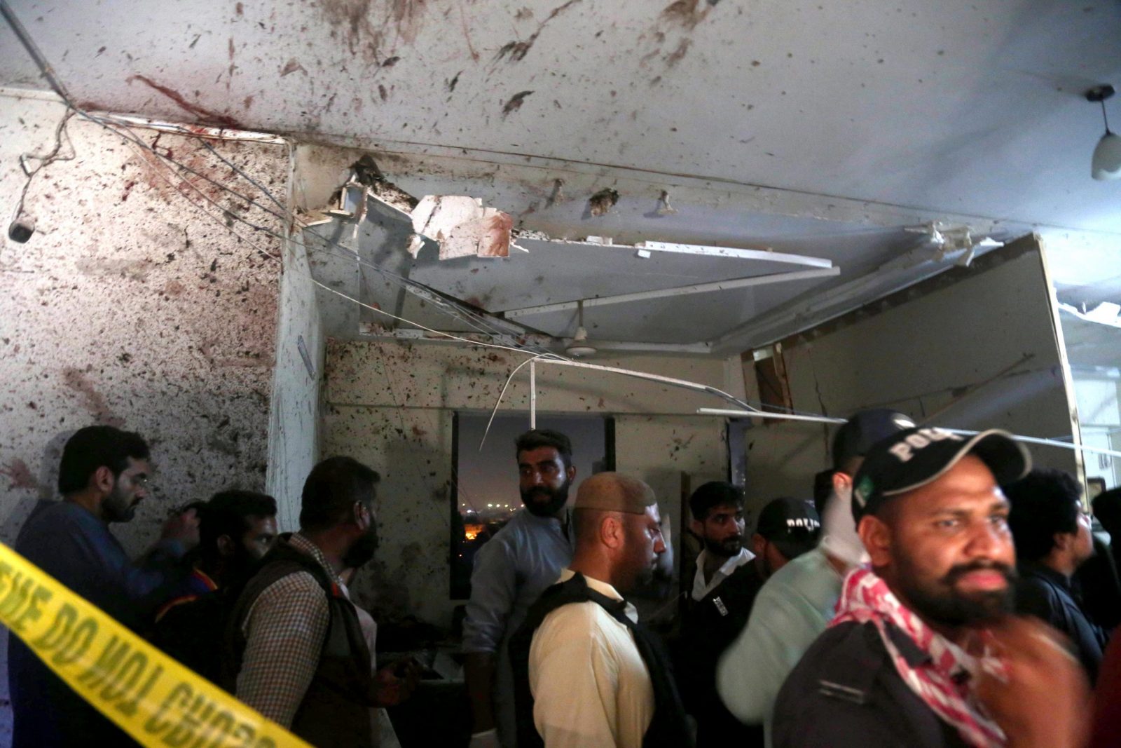 epa10473527 Pakistani security officials inspect the scene of an attack by gunmen targeting the office of the Karachi Police chief, in Karachi, Pakistan, 17 February 2023. According to police, at least three police officials were killed and 11 were injured after gunmen attacked the office of the Karachi police chief located on Main Sharea Faisal, with an operation currently underway.  EPA/REHAN KHAN