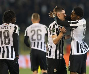 epa10486017 Partizan's Queensy Menig (R) celebrates with teammates after scoring the 1-0 lead during the UEFA Europa Conference League play-off, 2nd leg match between Partizan and Sheriff in Belgrade, Serbia, 23 February 2023.  EPA/ANDREJ CUKIC