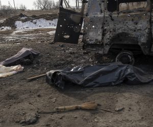epa10489118 Covered bodies of two locals killed in shelling lie on a road in Bakhmut, Ukraine, 24 February 2023. Russian troops entered Ukrainian territory on 24 February 2022, starting a conflict that has provoked destruction and a humanitarian crisis. One year on, fighting continues in many parts of the country.  EPA/GEORGE IVANCHENKO