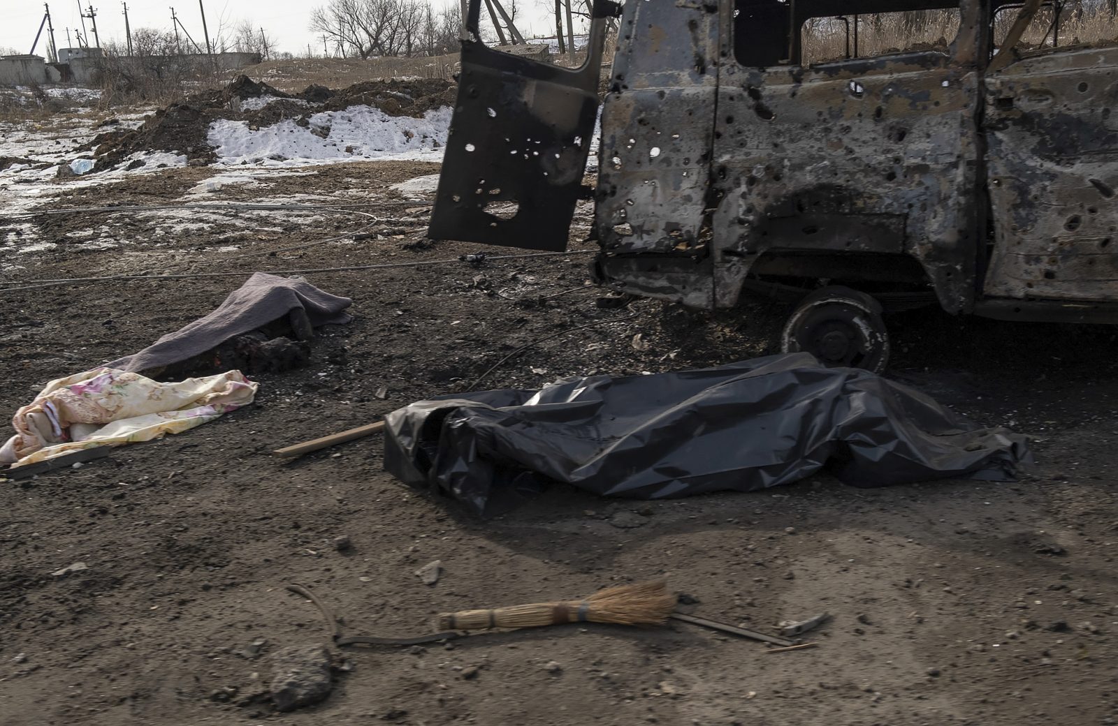 epa10489118 Covered bodies of two locals killed in shelling lie on a road in Bakhmut, Ukraine, 24 February 2023. Russian troops entered Ukrainian territory on 24 February 2022, starting a conflict that has provoked destruction and a humanitarian crisis. One year on, fighting continues in many parts of the country.  EPA/GEORGE IVANCHENKO