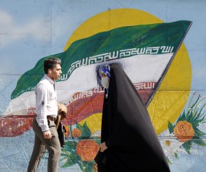 epa10493674 Iranians walk past next to a wall painting of Iran's national flag in downtown Tehran, Iran, 27 February 2023. According to Isna news agency, Iranian foreign minister Amir-Abdoulahian on 26 February 2023 said that Iran is close to reach a nuclear deal with US, after receiving a message from US through Iraq. Iran faces an economic crisis after its currency dropped to its lowest value against the US dollar and other foreign currencies last week, following sanctions imposed by the US and EU, amid tensions over nuclear talks, which have stopped in the wake of recent anti-government protests in the country.  EPA/ABEDIN TAHERKENAREH