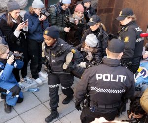 epa10496453 Police remove Swedish environmental activist Greta Thunberg (C) and other campaigners as they demonstrate outside the norway's Ministry of Finance entrance and several other ministries in a protest against still operating wind turbines at Fosen, in Oslo, Norway, 01 March 2023. Norway's Supreme Court has ruled in 2021 the wind turbines at Fosen are illegal.  EPA/ALF SIMENSEN  NORWAY OUT