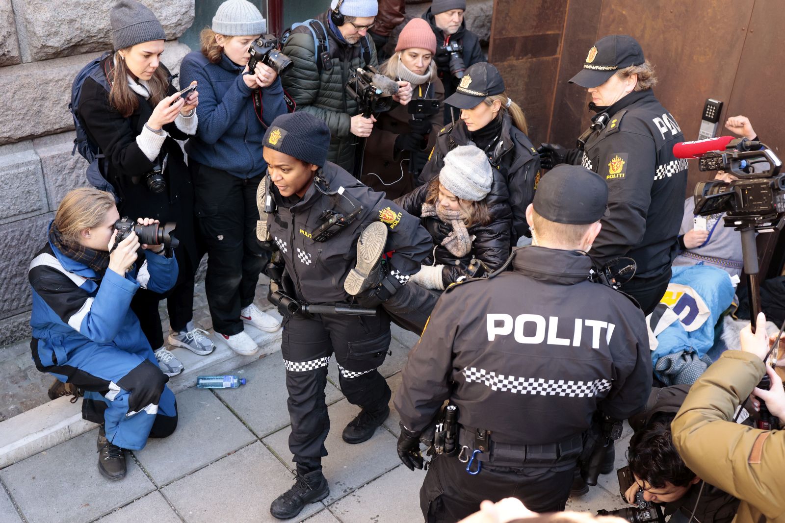 epa10496453 Police remove Swedish environmental activist Greta Thunberg (C) and other campaigners as they demonstrate outside the norway's Ministry of Finance entrance and several other ministries in a protest against still operating wind turbines at Fosen, in Oslo, Norway, 01 March 2023. Norway's Supreme Court has ruled in 2021 the wind turbines at Fosen are illegal.  EPA/ALF SIMENSEN  NORWAY OUT