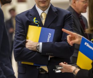 epa10498515 European ambassadors to the UN carry folders and ribbons in support of Ukraine during a session of the Conference on Disarmament at the European headquarters of the United Nations in Geneva, Switzerland, 02 March 2023.  EPA/MARTIAL TREZZINI