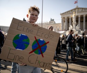 epa10500430 A protester holds a placard reading 'One Earth One Chance' during a Fridays for Future global climate strike demonstration in the city center of Vienna, Austria, 03 March 2023.  EPA/CHRISTIAN BRUNA