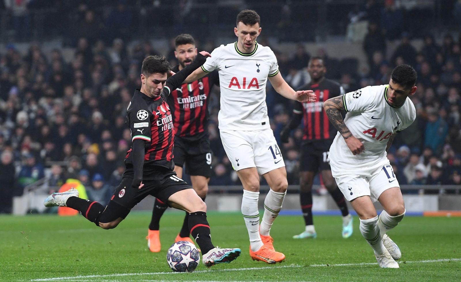 epa10510371 AC Milan's Brahim Diaz (L) takes a shot on goal as Tottenham's Ivan Perisic (C) and Rafael Leao (R) look on during the UEFA Champions League, Round of 16, 2nd leg match between Tottenham Hotspur and AC Milan in London, Britain, 08 March 2023.  EPA/Andy Rain