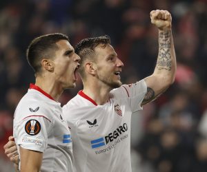 epa10512604 Sevilla's midfielder Erik Lamela (L) celebrates with teammate Ivan Rakitic (R) after scoring the 2-0 goal during the UEFA Europa League Round of 16, 1st leg match between Sevilla FC and Fenerbahce SK, in Seville, southern Spain, 09 March 2023.  EPA/JULIO MUNOZ