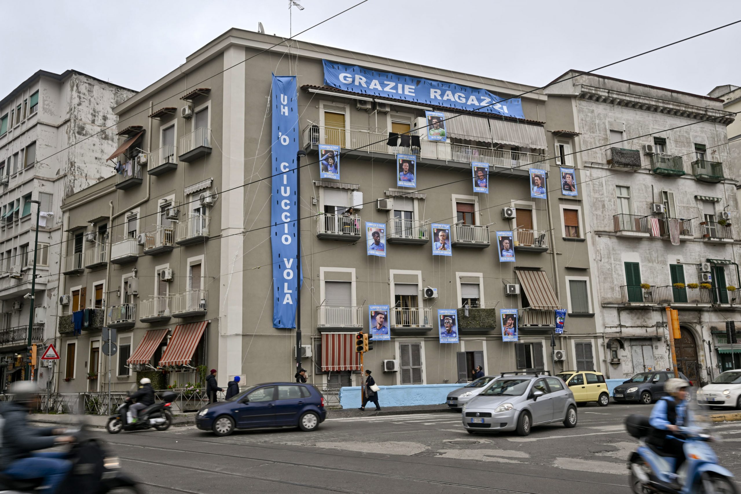 epa10513660 Pictures of 11 SSC Napoli players and their coach are arranged to look like a sticker album page along the four floors of a building's facade in the area of the central station in Naples, Italy, 10 March 2023. At thirteen rounds from the end of the Serie A soccer championship, SSC Napoli fans are already beginning to celebrate the victory of the Scudetto.  EPA/CIRO FUSCO