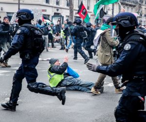 epa10515652 A demonstrator on the ground during a police charge during a new demonstration against the government's reform of the pension system in Paris, France, 11 March 2023. Protests continue across the country due to the French government's plan to delay the minimum retirement age from 62 to 64 by 2030. On 09 March, a majority of senators validated the postponement of the legal retirement age to 64 years. If they agree on a text, the final adoption of the reform could take place on 16 March.  EPA/TERESA SUAREZ