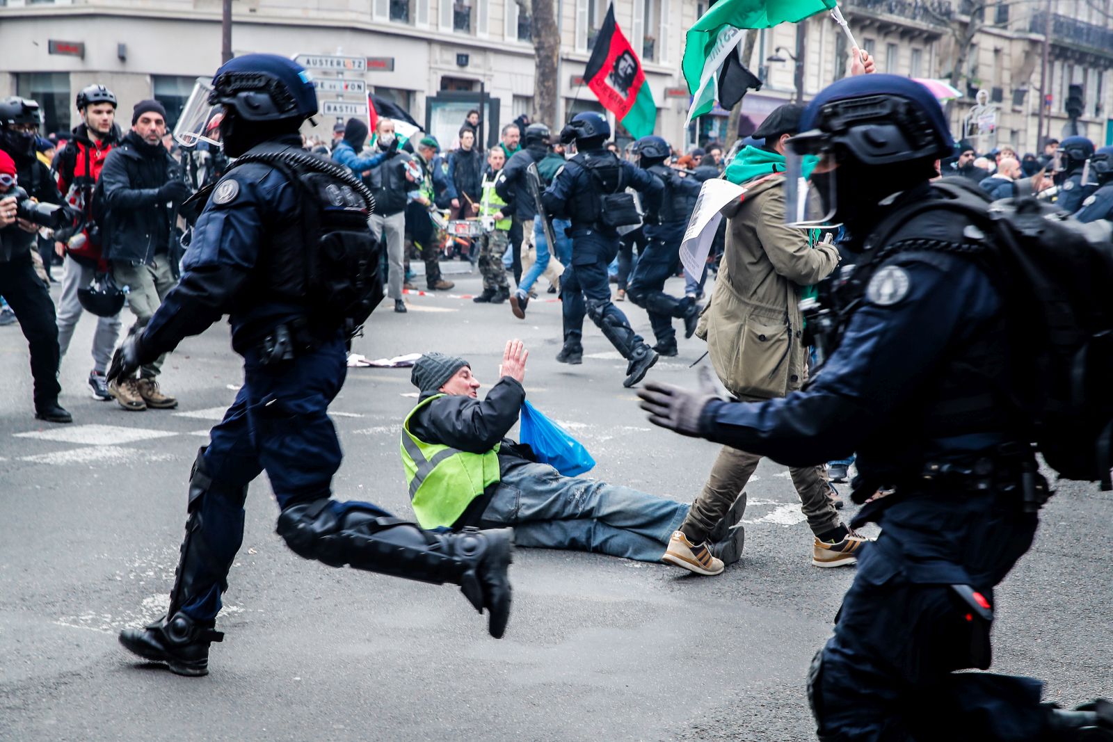 epa10515652 A demonstrator on the ground during a police charge during a new demonstration against the government's reform of the pension system in Paris, France, 11 March 2023. Protests continue across the country due to the French government's plan to delay the minimum retirement age from 62 to 64 by 2030. On 09 March, a majority of senators validated the postponement of the legal retirement age to 64 years. If they agree on a text, the final adoption of the reform could take place on 16 March.  EPA/TERESA SUAREZ