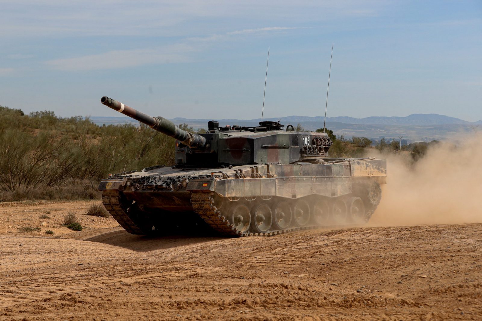 epa10520432 One of the Spanish Leopard 2A4 tanks that will be sent to Ukraine is maneuvered during a training with Ukrainian soldiers at the San Gregorio military base in Zaragoza, Spain, 13 March 2023. According to Spain's Defence Minister Margarita Robles, Spain will send a first shipment of six Leopard 2A4 tanks and plans to send more to Ukraine while they are also training 55 Ukrainian soldiers, including 40 in the handling of the tanks as crew and others in the tanks' maintenance.  EPA/Javier Cebollada