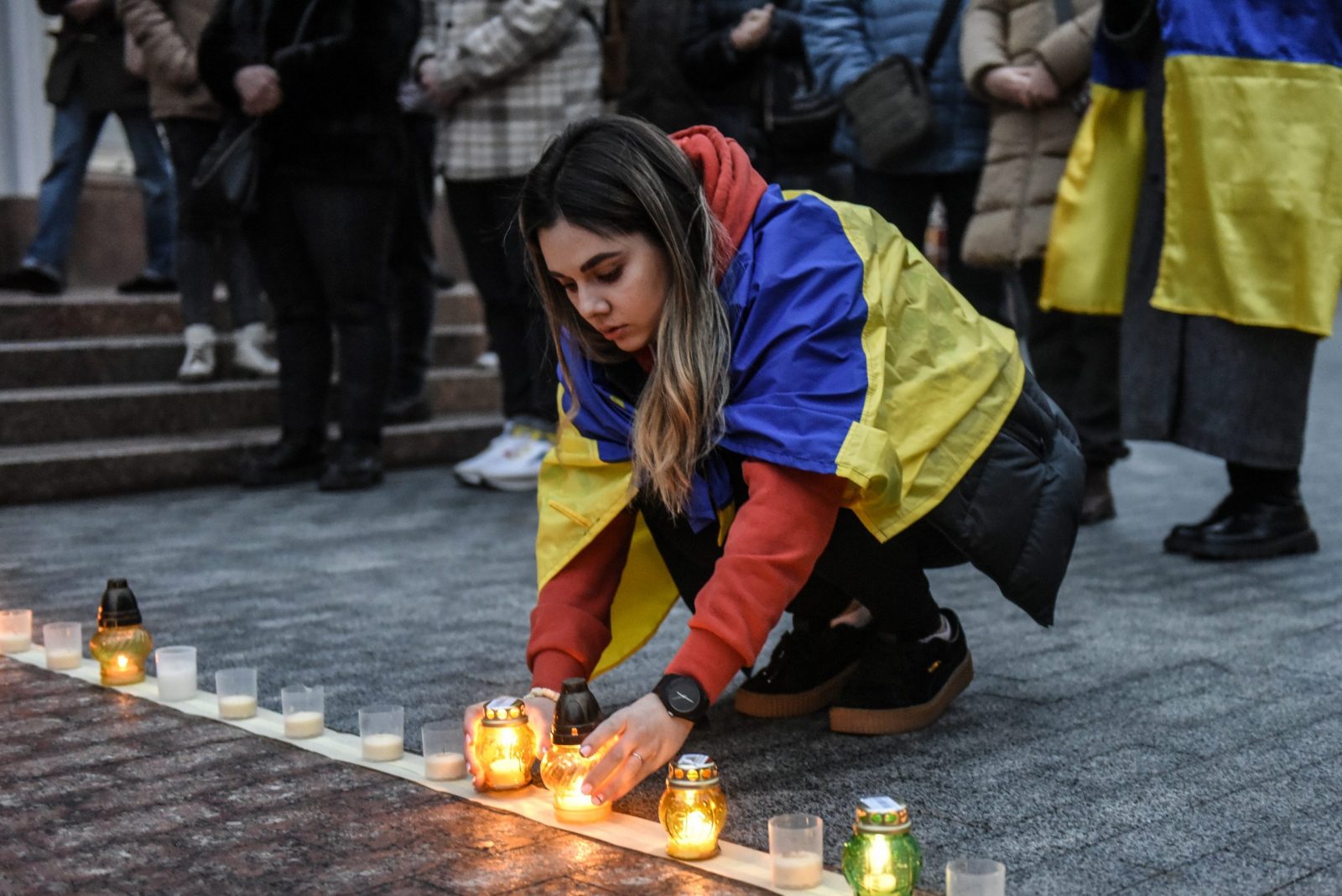 epa10526968 A woman lights candles and arranges them to form the word 'Children' as they attend a commemorative rally to mark the first anniversary of the bombing of the Mariupol Drama Theatre, in front of the National Opera of Ukraine in Kyiv (Kiev), Ukraine, 16 March 2023. The Drama Theater was destroyed on 16 March 2022 during Russian airstrikes and the siege of the southern Ukrainian port city of Mariupol. According to Amnesty International Ukraine at least 300 people died in the attack on the theatre, where a large number of civilians were hiding and the word 'Children' was written outside the building. Russian troops entered Ukrainian territory on 24 February 2022, starting a conflict that has provoked destruction and a humanitarian crisis.  EPA/OLEG PETRASYUK