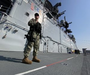 epa10534403 An armed US navy sailor conducts a patrol on the deck of the USS America (LH-6) amphibious assault ship docked at Port of Manila, in Manila, Philippines, 21 March 2023. Manila and Washington agreed on US troops having access to four new bases and allow an increase its military footprint in the country under the Enhanced Defense Cooperation Agreement (EDCA).  EPA/FRANCIS R. MALASIG