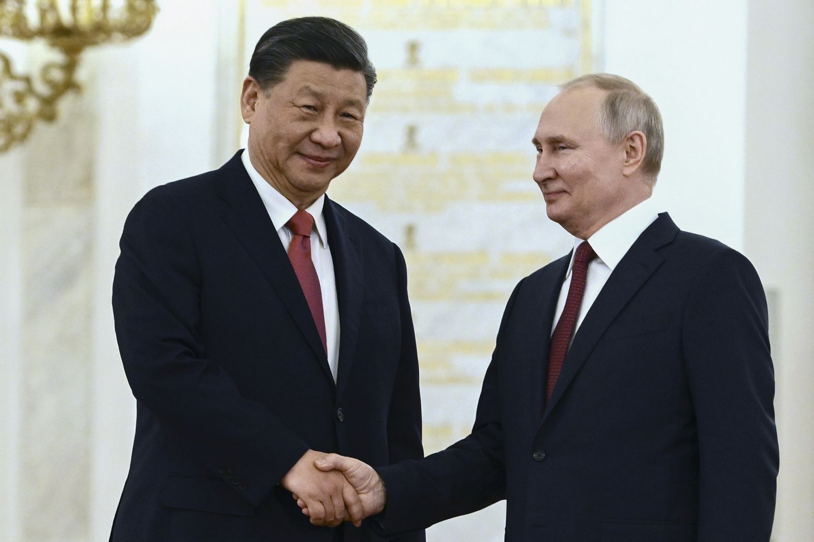epa10535018 Chinese President Xi Jinping (L) shakes hands with Russian President Vladimir Putin (R) during a welcome ceremony before the Russia - China talks in narrow format at the Kremlin in Moscow, Russia, 21 March 2023. Chinese President Xi Jinping arrived in Moscow on a three-day visit, from March 20 to 22, according to Russian and Chinese state agencies. Xi Jinping visits Russia on improving joint partnerships and developing key areas of Russian-Chinese economic cooperation.  EPA/ALEXEY MAYSHEV / SPUTNIK / KREMLIN POOL MANDATORY CREDIT