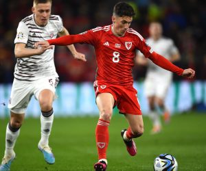 epa10547646 Harry Wilson (R) of Wales in action against Kristers Tobers
 of Latvia during the UEFA EURO 2024 qualification match between Wales and Latvia in Cardiff, Britain, 28 March 2023.  EPA/Peter Powell