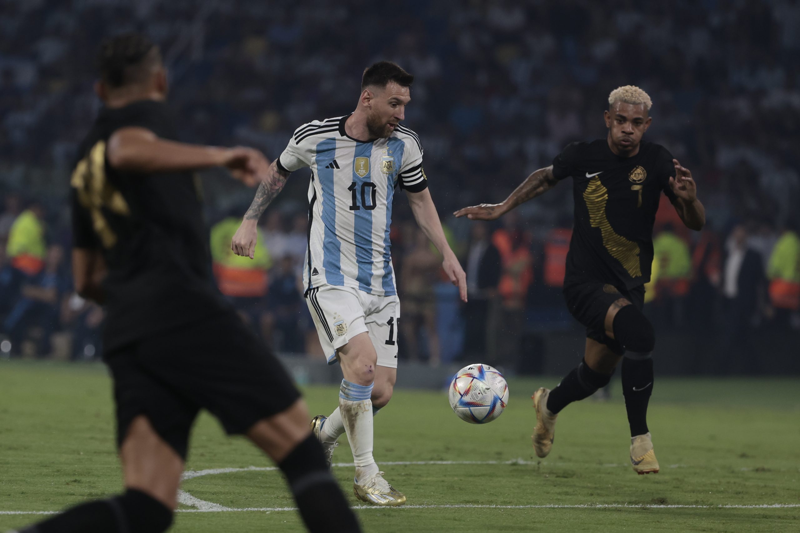 epa10548171 Lionel Messi (C) of Argentina vies for the ball with Juninho Bacuna (R) of Curacao during an international friendly soccer match between Argentina and Curacao at Unico Madre de Ciudades stadium in Santiago del Estero, Argentina, 28 March 2023.  EPA/Juan Ignacio Roncoroni