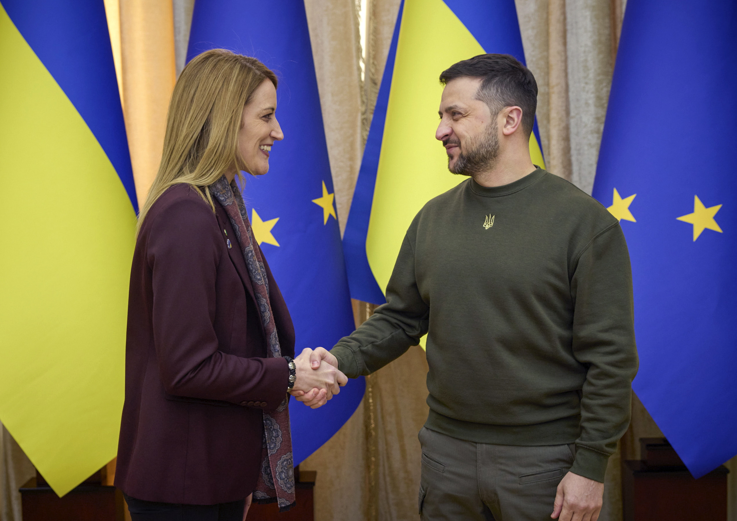 epa10502526 A handout photo made available by the Ukrainian Presidential Press Service shows Ukraine's President Volodymyr Zelensky (R) and Roberta Metsola (L), the President of the European Parliament, pose for a handshake prior their meeting in Lviv, Ukraine, 04 March 2023. Metsola arrived in Ukraine to meet with top officials and express their support for Ukraine amid the Russian invasion.  EPA/UKRAINE PRESIDENTIAL PRESS SERVICE HANDOUT  HANDOUT EDITORIAL USE ONLY/NO SALES