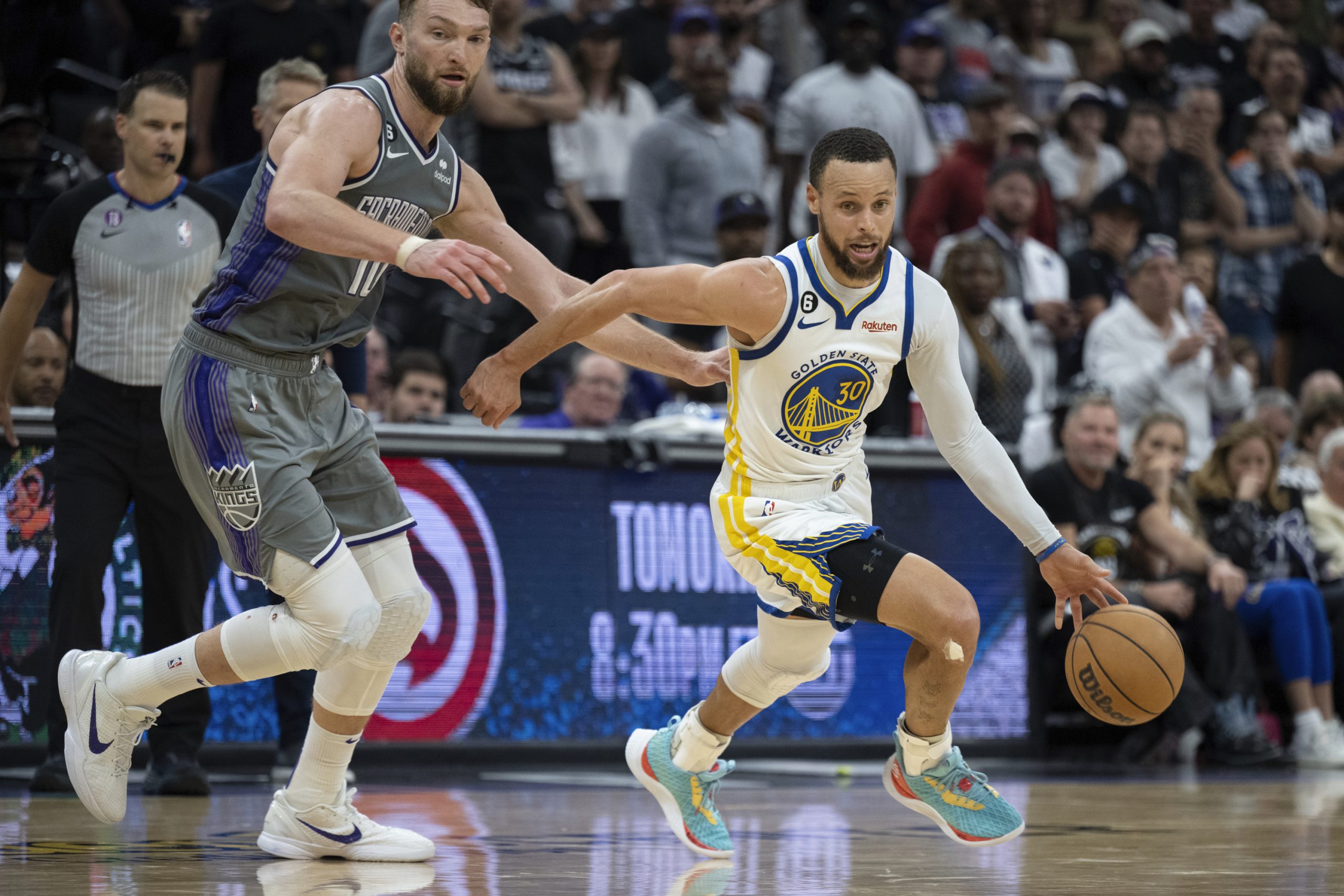 Sacramento Kings forward Domantas Sabonis (10) chases Golden State Warriors guard Stephen Curry (30) during the second half of Game 5 of an NBA basketball first-round playoff series Wednesday, April 26, 2023, in Sacramento, Calif. The Warriors won 123-116. (AP Photo/José Luis Villegas)
