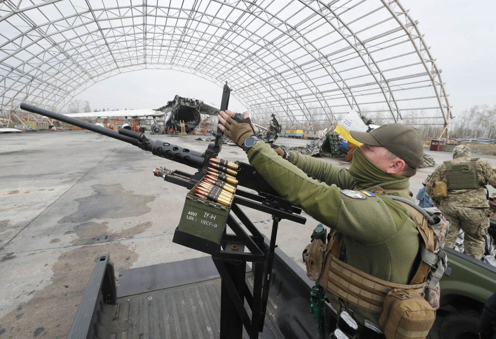 epa10553623 A Ukrainian serviceman handles a machine gun during the handing over of ten pick-up trucks to mobile anti-drone units near the largest Ukrainian cargo aircraft Antonov An-225 Mriya 'Dream' that was destroyed during the Russian attacks on Hostomel Airfield not far from Kyiv, Ukraine, 01 April 2023 amid the Russian invasion. Mobile anti-drone units have the task to track and destroy enemy kamikaze drones and other low-flying aerial targets. Russian troops on 24 February 2022, entered Ukrainian territory, starting a conflict that has provoked destruction and a humanitarian crisis.  EPA/SERGEY DOLZHENKO