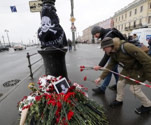 epa10556941 Men lay flowers at a makeshift memorial for Russian military blogger Vladlen Tatarsky, who was killed in the April 02 bomb blast in a cafe, in St. Petersburg, Russia, 03 April 2023. According to Russia's Ministry of Internal Affairs, as a result of the explosion, blogger Vladlen Tatarsky, whose real name is Maxim Fomin, died and at least thirty people were injured.  EPA/ANATOLY MALTSEV