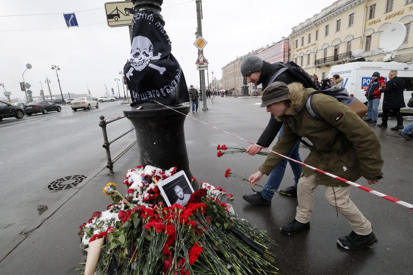epa10556941 Men lay flowers at a makeshift memorial for Russian military blogger Vladlen Tatarsky, who was killed in the April 02 bomb blast in a cafe, in St. Petersburg, Russia, 03 April 2023. According to Russia's Ministry of Internal Affairs, as a result of the explosion, blogger Vladlen Tatarsky, whose real name is Maxim Fomin, died and at least thirty people were injured.  EPA/ANATOLY MALTSEV