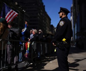 epa10557479 A police officer watches supporters of former US president Donald J. Trump stand near Trump Tower in New York, New York, USA, 03 April 2023. After being indicted by a Manhattan grand jury last week, Trump traveled to New York and will reportedly turn himself in on 04 April at New York Criminal Court to hear the charges against him.  EPA/WILL OLIVER