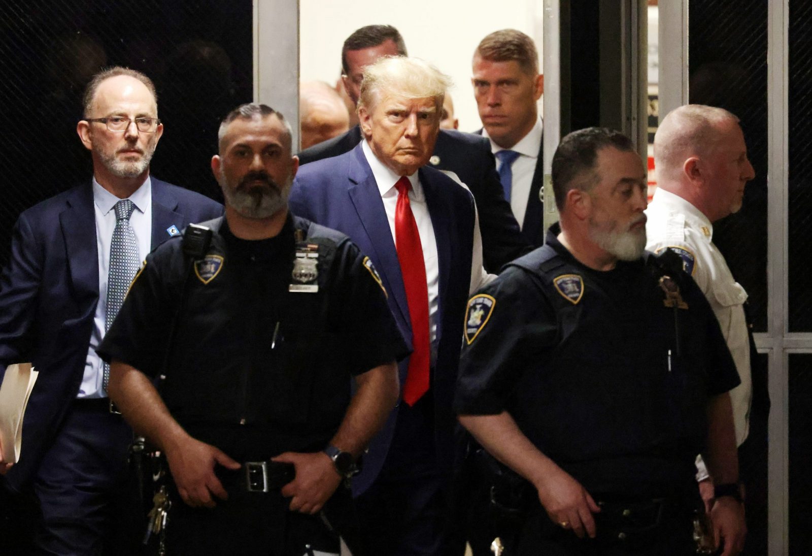 epa10558601 Former US President Donald J. Trump walks towards the courtroom inside New York Criminal Court in New York, New York, USA, 04 April 2023. A Manhattan grand jury voted to indict former President Donald J. Trump last week and he will turn himself in at the courthouse and appear before a judge to hear the charges against him later today.  EPA/JUSTIN LANE