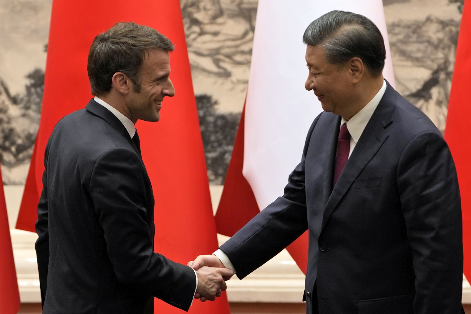 epa10561265 French President Emmanuel Macron (L) shakes hands with Chinese President Xi Jinping (R) after meeting the press at the Great Hall of the People in Beijing, China, 06 April 2023.  EPA/Ng Han Guan / POOL