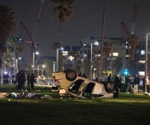 epa10564161 Israeli policemen work at the scene of a shooting and ramming attack in Tel Aviv, Israel, 07 April 2023. According to Israeli police, one tourist was shot and killed and five others were injured when a driver rammed his car into passers-by on the beach promenade of Tel Aviv.  EPA/ABIR SULTAN