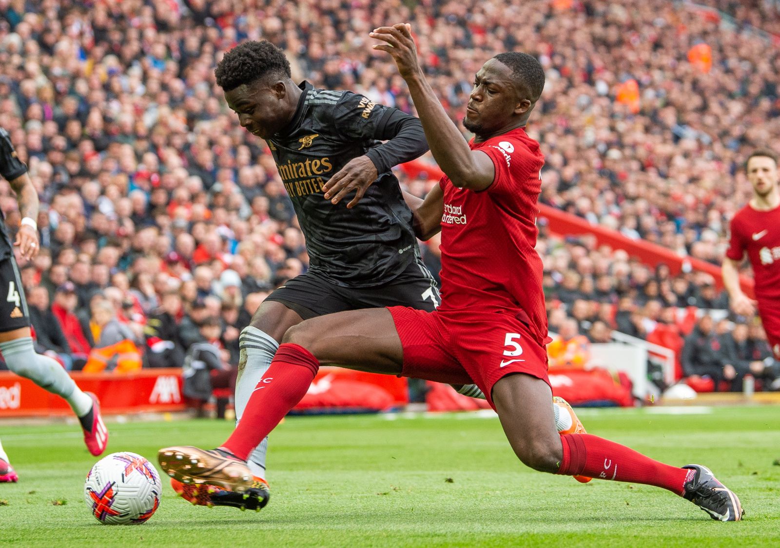 epa10566463 Arsenal's Bukayo Saka (L) in action with Liverpool's Ibrahima Konate  (R) during the English Premier League soccer match between Liverpool and Arsenal at Anfield in Liverpool, Britain, 09 April 2023.  EPA/PETER POWELL EDITORIAL USE ONLY. No use with unauthorized audio, video, data, fixture lists, club/league logos or 'live' services. Online in-match use limited to 120 images, no video emulation. No use in betting, games or single club/league/player publications