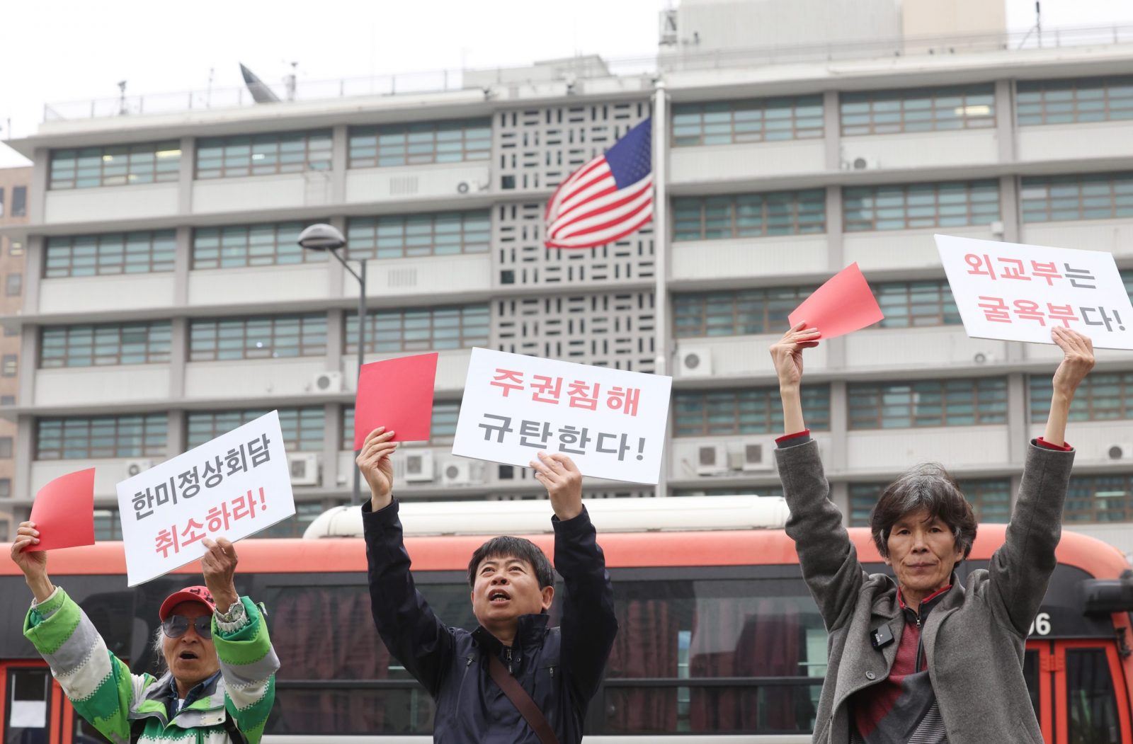 epa10568020 Members of a civic group show red cards during a rally near the US Embassy in Seoul, South Korea, 11 April 2023, to urge the United States to issue an apology for its alleged attempts to eavesdrop on top South Korean officials.  EPA/YONHAP SOUTH KOREA OUT