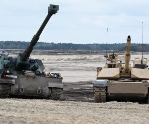 epa10569707 Abrams tank (R) and Krab self-propelled cannon howitzer (L) during the training of Polish and American soldiers at the training ground in Nowa Deba, southeast Poland, 12 April 2023.  EPA/Darek Delmanowicz POLAND OUT