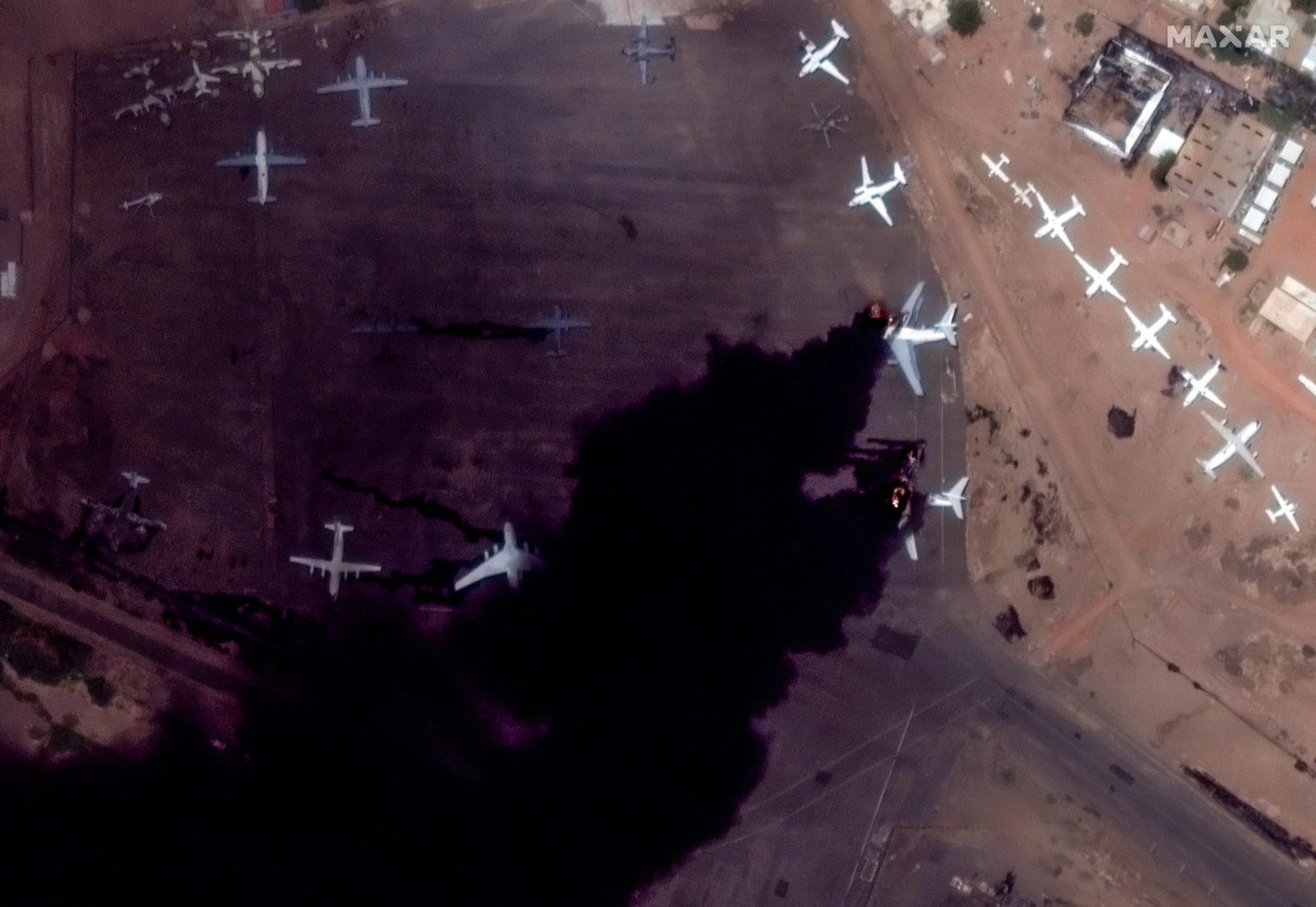 epa10576099 A handout satellite image made available by Maxar Technologies shows burning Il-76 transport aircraft at Khartoum International Airport, in Khartoum, Sudan, 16 April 2023. Heavy gunfire and explosions were reported in Sudan's capital Khartoum on 15 April between the army and a paramilitary group following days of tension centering around the country's proposed transition to civilian rule.  EPA/MAXAR TECHNOLOGIES HANDOUT -- MANDATORY CREDIT: SATELLITE IMAGE 2023 MAXAR TECHNOLOGIES -- THE WATERMARK MAY NOT BE REMOVED/CROPPED -- HANDOUT EDITORIAL USE ONLY/NO SALES