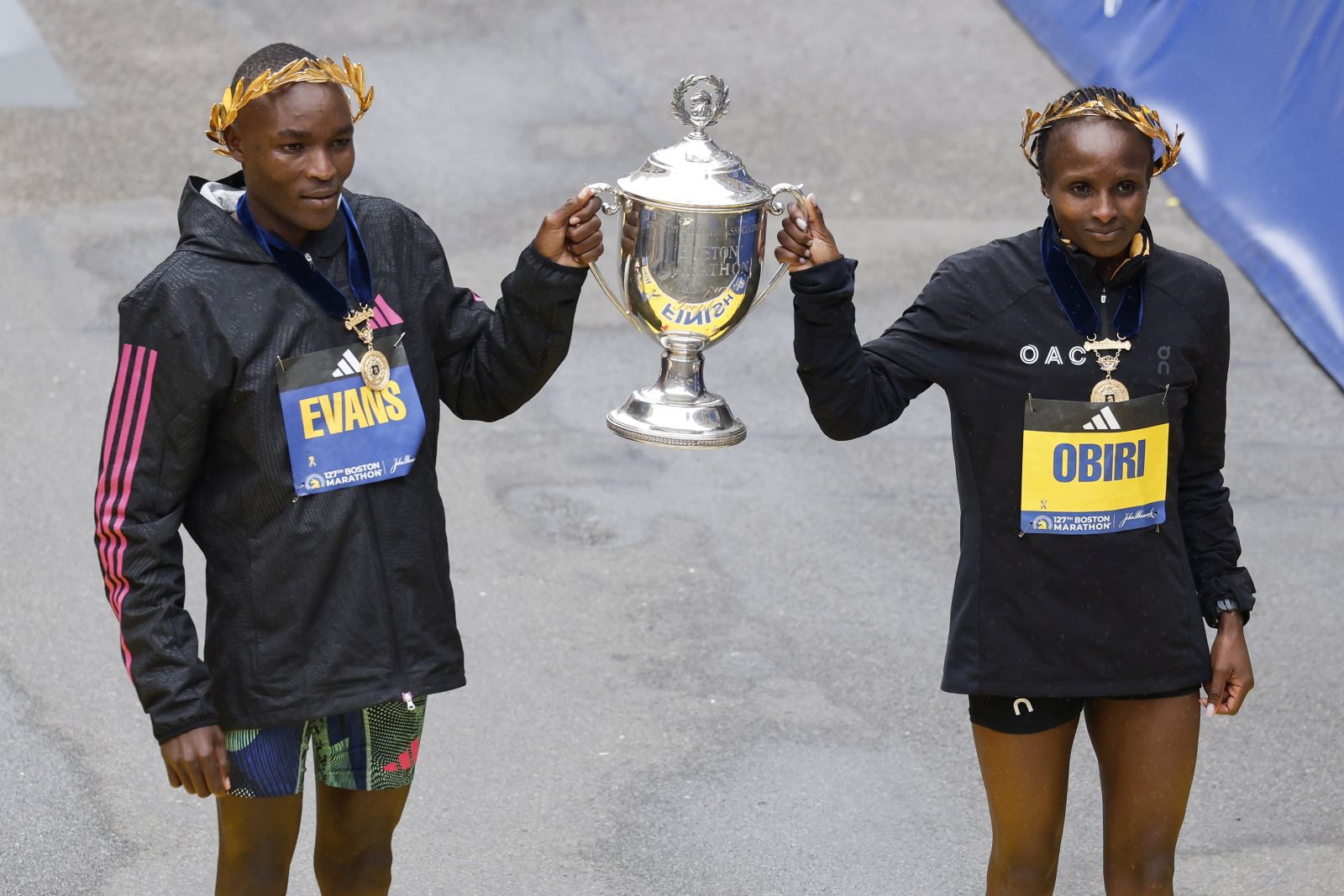 epa10577158 Evans Chebet of Kenya (L), winner of the Men’s Division of the 127th Boston Marathon, and Hellen Obiri of Kenya (R), winner of the Women’s Division of the 127th Boston Marathon, hold up a trophy as they celebrate their wins in Boston, Massachusetts, USA, 17 April 2023.  EPA/HERB SWANSON