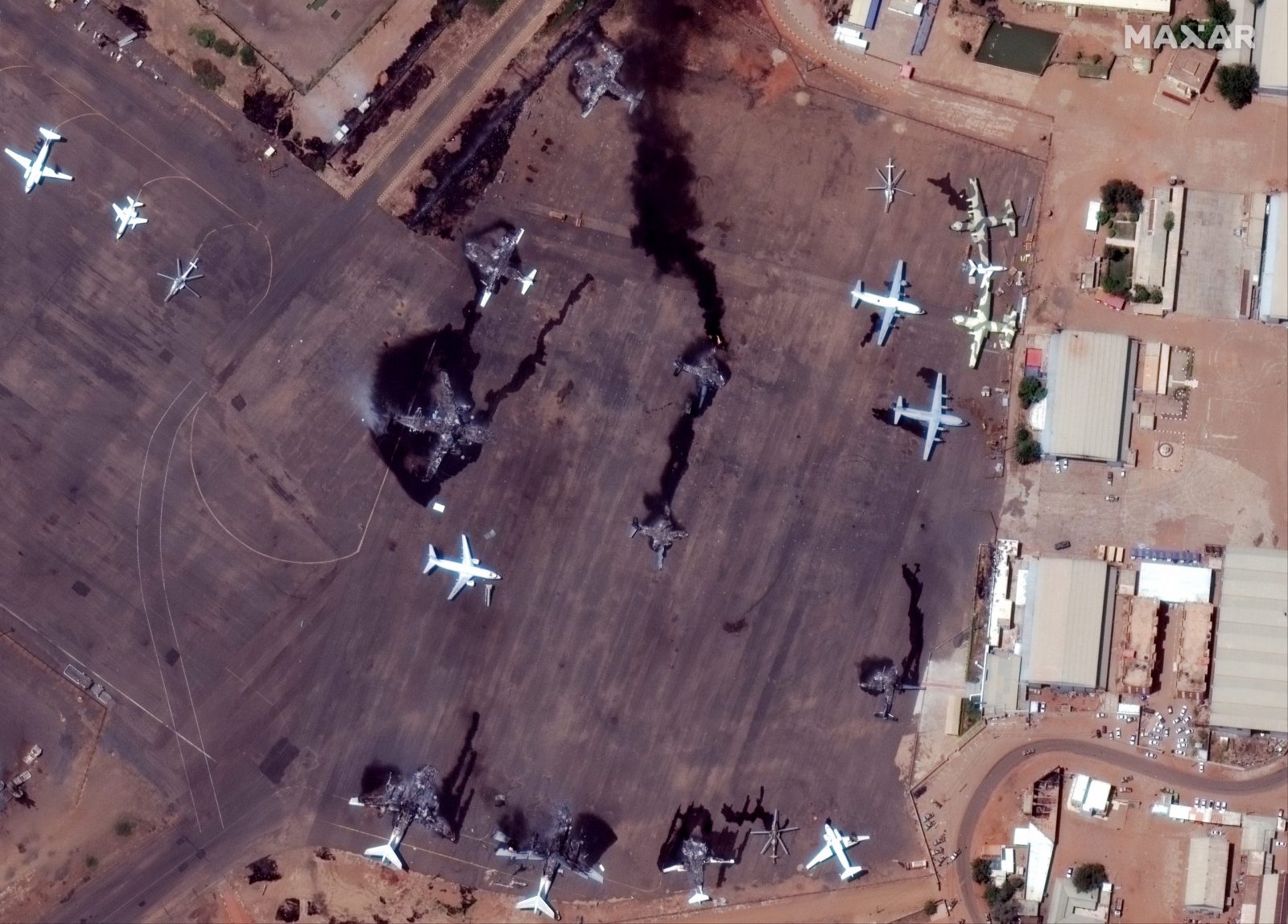epa10577398 A handout satellite image made available by Maxar Technologies shows smoke billowing from destroyed aircrafts at Khartoum International Airport, in Khartoum, Sudan, 17 April 2023. Heavy gunfire and explosions were reported in Sudan's capital Khartoum since 15 April between the army and a paramilitary group following days of tension centering around the country's proposed transition to civilian rule.  EPA/MAXAR TECHNOLOGIES HANDOUT -- MANDATORY CREDIT: SATELLITE IMAGE 2023 MAXAR TECHNOLOGIES -- THE WATERMARK MAY NOT BE REMOVED/CROPPED -- HANDOUT EDITORIAL USE ONLY/NO SALES