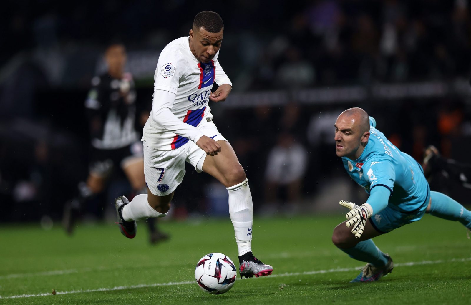 epa10584552 Kylian Mbappe of PSG (L) of Paris scores the 0-2 lead goal against Angers goalkeeper Paul Bernardoni (R)  during the French Ligue 1 soccer match between Angers and Paris Saint Germain in Angers, France, 21 April 2023.  EPA/MOHAMMED BADRA