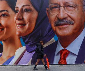 epa10591376 A woman walks in front of the picture of Turkish presidential candidate Kemal Kilicdaroglu's, leader of opposition Republican People’s Party (CHP), in Istanbul, Turkey, 25 April 2023. General elections will be held in Turkey on 14 May 2023 with a two-round voting to elect the President of Turkey and parliamentary elections held simultaneously to elect the members the Grand National Assembly of Turkey.  EPA/SEDAT SUNA