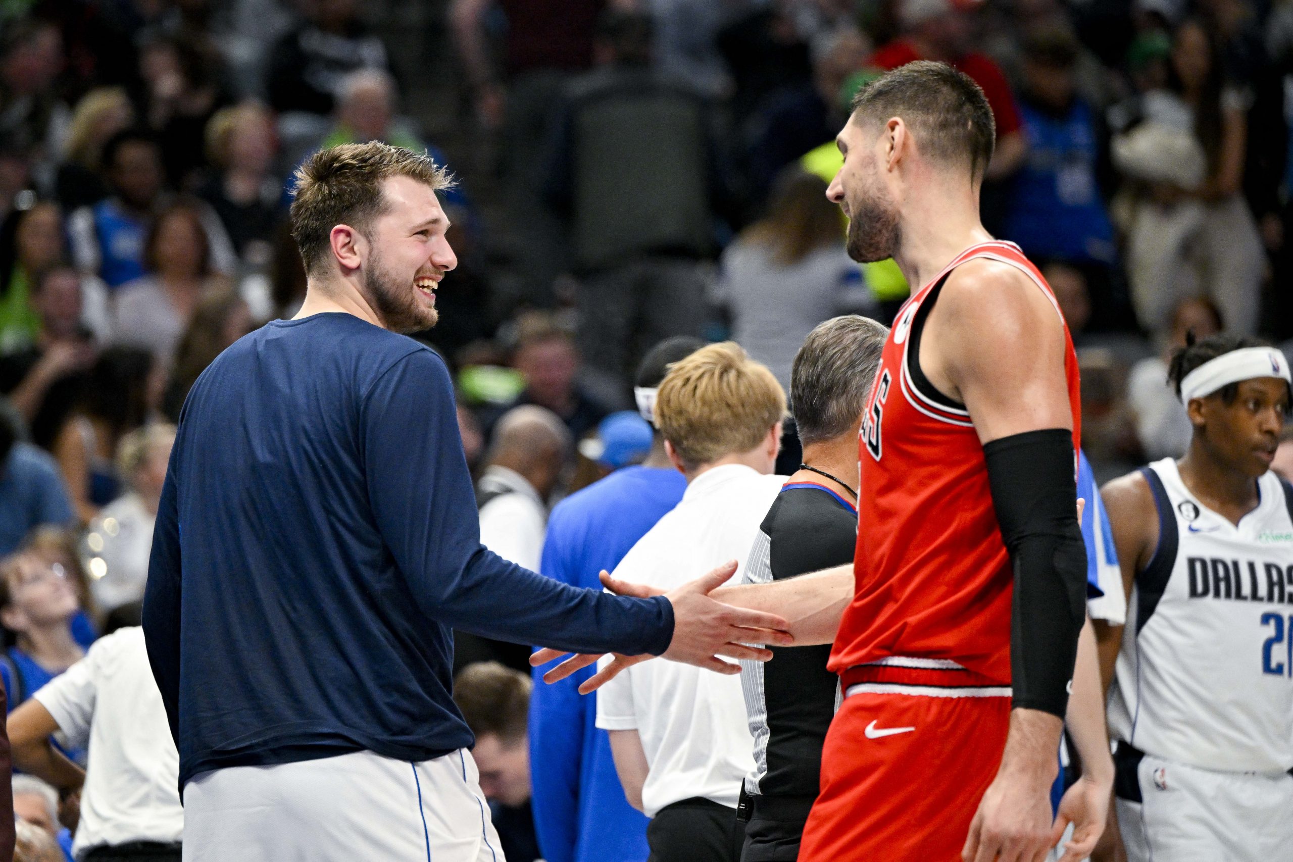 Apr 7, 2023; Dallas, Texas, USA; Dallas Mavericks guard Luka Doncic (77) jokes with Chicago Bulls center Nikola Vucevic (9) during a timeout in the game at the American Airlines Center. Mandatory Credit: Jerome Miron-USA TODAY Sports Photo: Jerome Miron/REUTERS