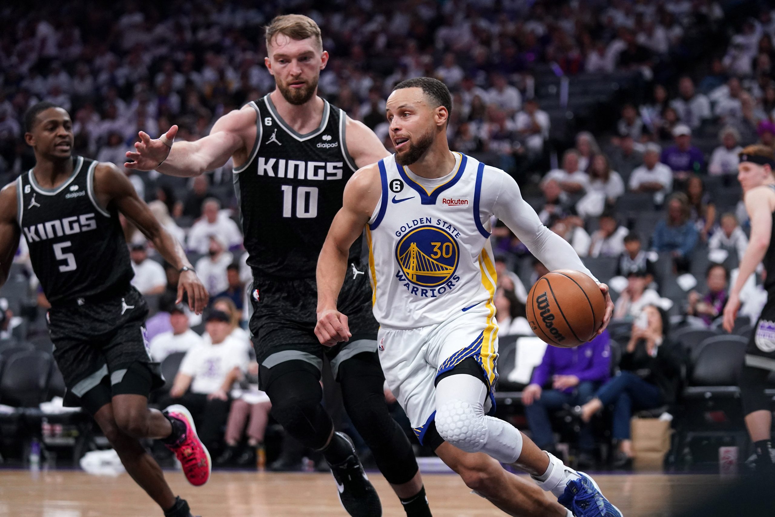 Apr 15, 2023; Sacramento, California, USA; Golden State Warriors guard Stephen Curry (30) dribbles past Sacramento Kings forward Domantas Sabonis (10) in the third quarter during game one of the 2023 NBA playoffs at the Golden 1 Center. Mandatory Credit: Cary Edmondson-USA TODAY Sports Photo: Cary Edmondson/REUTERS