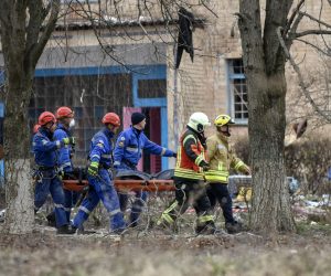epa10537059 Rescue workers carry the body of a victim at the site of a buliding damaged by drone strikes in the town of Rzhyshchiv, Ukraine, 22 March 2023. According to the State Emergency Service of Ukraine, at least six people died on 22 March following a Russian overnight drone strikes on Rzhyshchiv.  EPA/OLEG PETRASYUK