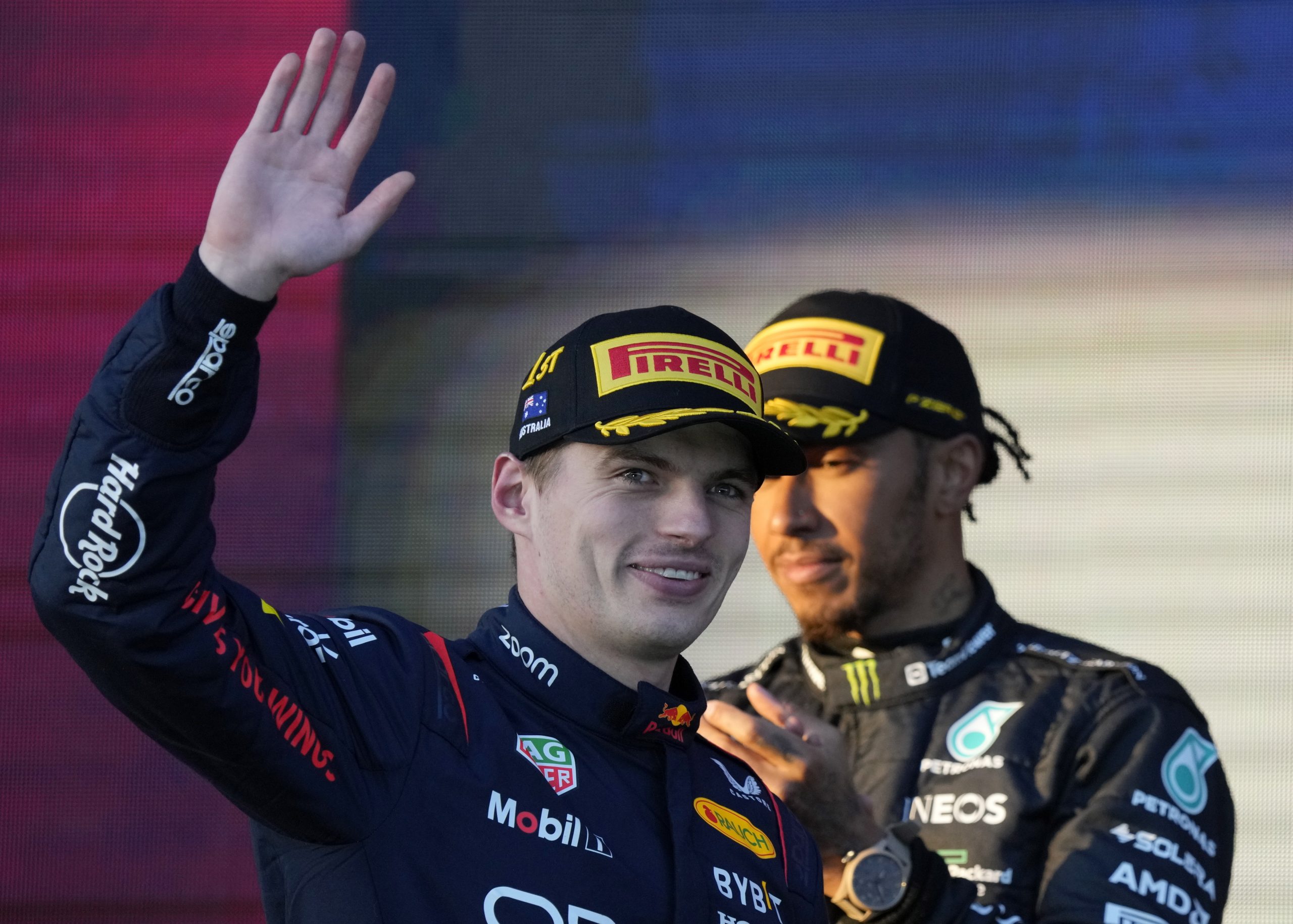 epa10555023 Dutch Formula One driver Max Verstappen (front) of Red Bull Racing reacts after winning the Formula One Grand Prix of Australia as second-placed British Formula One driver Lewis Hamilton (back) of Mercedes-AMG Petronas looks on at the Albert Park Circuit in Melbourne, Australia, 02 April 2023.  EPA/SIMON BAKER